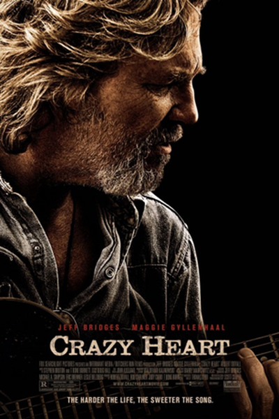 A movie poster for the film "Crazy Heart" starring Jeff Bridges and Maggie Gyllenhaal. The poster features a close-up of Jeff Bridges' face with a serious expression on his face. He is holding a guitar and appears to be playing it. The background is black and the title of the film is written in white text at the top and bottom of the poster. The tailing "The harder the life the sweeter the song" is written at the bottom.