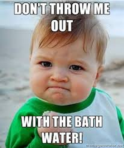 A meme featuring a photo of a baby on a beach. The baby is wearing a green bib and has a sad expression on their face. The text on the image reads "Don't throw me out with the bath water!" The background is blurred but it appears to be a sandy beach with the ocean in the distance.
