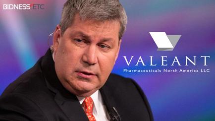 A close-up of a man's face. He appears to be in his late 40s or early 50s with short grey hair and a serious expression. He is wearing a black suit and a red tie. The background is blurred but it seems like he is on a stage or a panel discussion. On the right side of the image there is a logo for valiant Pharmaceuticals North America LLC which is a white triangle with the company name written in blue.