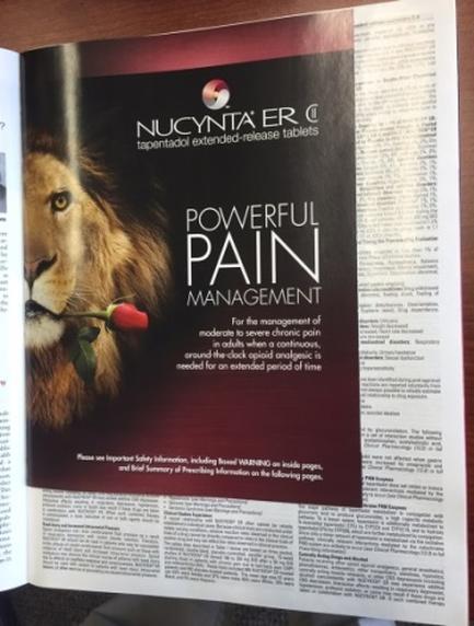 A photograph of a magazine spread from the brand NUCYNTA ER. The magazine is titled "Powerful Pain Management" and has a picture of a lion on the left side of the page. The lion is holding a red rose in its mouth and is looking directly at the camera. The background is black and the text is in white. The text on the page is in a bold font and is divided into two columns. The top column has the brand's logo and the bottom column has a description of the product which reads "Tapentadol extended-release tablets". The text below the description explains that the product is for the management of moderate pain and that it is needed for an extended period of time.