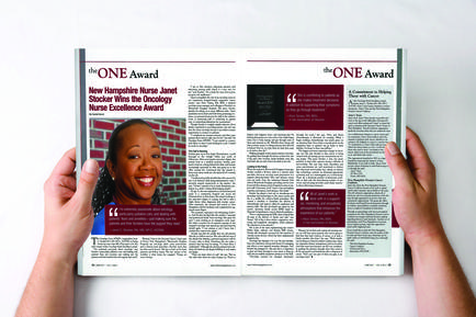 A photograph of a person holding a magazine spread. The magazine is titled "The ONE Award" and has a photo of a woman on the left side of the page. The woman is wearing a blue shirt and has long dark hair. She is smiling and looking directly at the camera. On the right side there is a text that reads "New Hampshire Nurse Janet sticker Wins Oncology Nurse Excellence Award". Below the photo there are two smaller text boxes with the same text. The text boxes are divided into two columns with the left column containing the title of the magazine and the right column containing a brief description of the award. The background of the image is white.