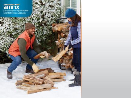 A man and a woman in a snowy yard. They are both wearing winter clothes with the man wearing an orange vest a beanie and gloves and the woman wearing a blue beanie and a plaid shirt. The man is kneeling on the ground and is holding a pile of firewood while the woman is standing next to him holding a wooden log. They appear to be sorting through the firewood. In the background there is a pile and a bush covered in snow. The image also has a logo for Amrix a company that provides extended-release capsules.