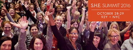 A large group of people with their hands up in the air smiling and cheering. They appear to be at a conference or event as indicated by the text on the top right corner of the image which reads "S.H.E. Summit 2016 October 28-29 92Y - NYC". The people in the image are of different ages genders and ethnicity's and they are all wearing casual clothing. The background is blurred but it appears to be a large room with a stage and a crowd of people.