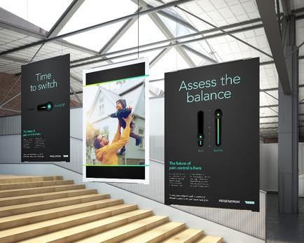 Three large black banners hanging from the ceiling of a modern building. The banners are arranged in a triangular formation with the largest banner on the left and the two smaller banners on the right. The banner in the center has a photo of a man holding a child in his arms and the text "Assess the balance" above it. Below the photo there is text that reads "Time to switch" and "The future of balance is here". The banners also have a green arrow pointing to the right indicating that the user can adjust the balance of the balance. The background of the image shows a set of stairs leading up to the second floor of the building.