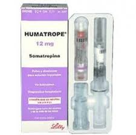 A product packaging of Humatropé 12 mg Somatropina. The packaging is a purple cardboard box with the brand name "Lilly" written in white text on the top left corner. On the right side of the box there is an image of the product which appears to be a syringe with a clear plastic body and a silver cap. The syringe has a red cap and a white label with the product name and dosage information. The label also mentions that the product is made with natural ingredients and is suitable for use in a variety of applications.