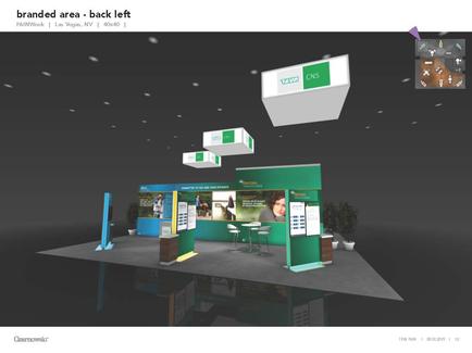 A 3D rendering of a trade show booth. The booth is green and white in color and has a modern design. It has a large screen on the left side of the booth displaying information about the company's products and services. On the right side there is a desk with a computer monitor and a plant in front of it. Above the desk there are several white boxes hanging from the ceiling. The background is black and there is text on the top right corner that reads "branded area - back left".