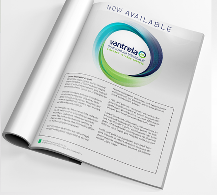 A photograph of an open brochure or magazine spread. The brochure is white with a blue and green circular logo in the center. The logo is for a company called cantrell and the text below it reads "Now Available". The text is written in black and is in a modern sans-serif font. The pages of the brochure are divided into two columns with the left column containing information about the company and the right column containing a brief description of the product. The background of the page is plain white.