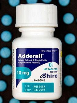 A white bottle of Adderall 10 mg tablets with blue and green packaging. The label on the front of the bottle indicates that it contains 100 tablets and is manufactured by Shire. There is also an expiration date printed on the label.