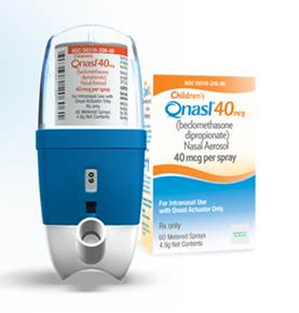 A blue and white nasal spray bottle with a label that reads "children Qnasl40.0" and "Bedomethasone diopropionate Nasal Aerosol 40 mcg per spray". The bottle is cylindrical in shape with a blue body and a white cap. The label also has a arcade and the product name printed on it. Next to the bottle there is an orange box with the same label. The box also states that the product is for children and that it is available for use with Oral Activator Only. There is also a label on the box that says "For Intensive Use with Oral Actuator Only". The background is white.