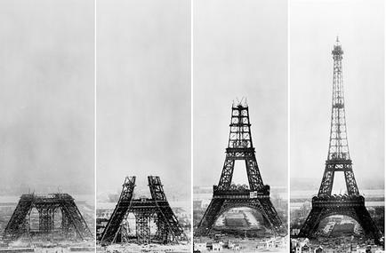 A collage of four black and white photographs of the Eiffel Tower in Paris France. The photographs are arranged in a grid-like pattern with each photograph showing a different angle of the tower. The first photograph on the top left shows the tower under construction with scaffolding around it. The tower appears to be in the process of being built as there are several pieces of scaffolding scattered around the base of the structure. The second photograph in the middle shows the same tower but it is still standing upright and appears to have been damaged. The third photograph shows the structure in the center with the scaffolding still intact. The fourth photograph shows a closer look at the structure with a few people visible in the foreground. All the photographs appear to be from the early 20th century as the sky is overcast and the overall mood of the image is somber.