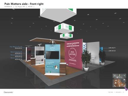 A 3D rendering of a trade show booth design. The booth is located in a large room with a high ceiling and black walls. There are three white boxes hanging from the ceiling each with a different color scheme - green pink and blue. In the center of the booth there is a large screen displaying information about the booth's features. On the left side of the screen there are two smaller screens displaying the same information. In front of the screens there appears to be a desk with a computer monitor and a plant in a pot. The booth also has a pink banner with the words "Pain Matters aisle - front right" written on it. The overall design is modern and professional with a focus on the front right side.