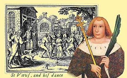 A black and white illustration of St. Virgil and his dance. He is standing in front of a group of people some of whom are dancing and some are standing on the ground. The man is holding a staff with a green feather on it. He has red hair and is wearing a white robe with a black collar. The background shows a church with a steeple and a cross on the front. The sky is blue and there are trees in the background. The text on the image reads "St Virgil and his Dance".