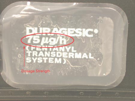 A clear plastic container with a label on it. The label reads "DURAGESIC 75 ug/h (Fentanyl Transdermal System" in bold white letters. The image has been edited so that the dosage information is circled in red and labeled with the text "dosage strength". The container appears to be sealed and is placed on a black surface.
