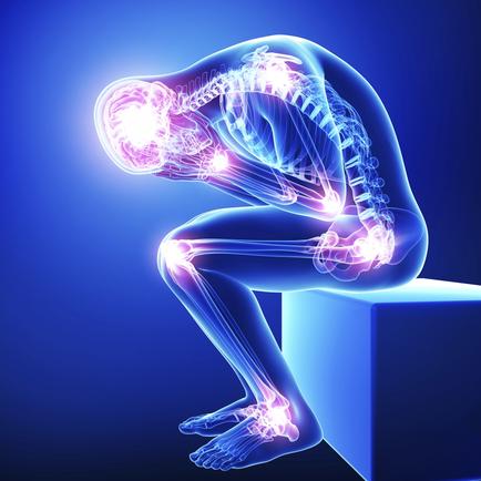 A 3D rendering of a human skeleton sitting on a blue cube. The skeleton is in a crouching position with its head resting on its knees and its arms stretched out to the sides. The bones of the skeleton are highlighted in pink and purple indicating that it is experiencing pain or discomfort. The background is a solid blue color and the overall mood of the image is one of discomfort and pain.