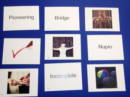 A collage of nine square cards arranged in a grid-like pattern on a blue background. Each card has a title written on it in white text. The first card on the top left reads "Pioneering" followed by "Bridge" "Nupio" and "Incomplete". Below the title there is a red checkmate indicating that the cards are related to the concept of pioneering. In the center of each card there are two images - one of a person standing on a bridge with their arms stretched out and the other of a group of people standing on top of it. The person on the bridge appears to be in a state of awe and wonder with their eyes closed and their head tilted back as if they are in awe of the world around them. The other two images on the bottom right corner of the cards show a person holding a colorful umbrella possibly representing the idea of a rainbow or a rainbow.