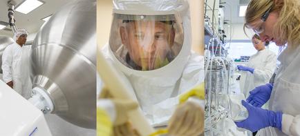 A collage of three photographs of a laboratory setting. The first photograph on the left shows a man wearing a white protective suit and a face shield working in a laboratory. He is standing in front of a large metal object which appears to be a machine or equipment. The second photograph in the middle shows a woman wearing a full-face protective suit with a transparent face shield. She is looking at the camera and appears to have a serious expression on her face. The third photograph on on the right shows a group of people working in the laboratory wearing white lab coats and blue gloves. They are working on various scientific equipment and tools. The background is blurred but it seems to be an industrial setting with other laboratory equipment and equipment visible. The overall mood of the image is focused and professional.