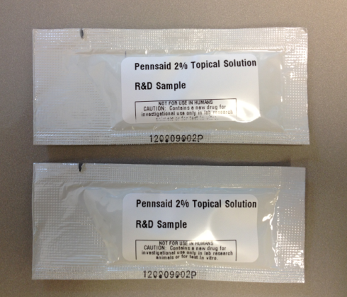 Two packets of Pennassay 24 Topical Solution labeled as "RAD Sample" on the front. The packets are white and have a clear plastic window in the center allowing for easy viewing of the product inside. The text on the label indicates that it is a sample and provides information about its use and storage conditions.