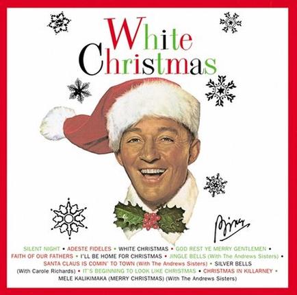 A cover of a Christmas album titled "White Christmas". The cover features a portrait of a man wearing a red Santa hat with a white fur trim and a holly wreath around his neck. He is smiling and looking directly at the camera. The background is white with black snowflakes scattered around. The title of the album is written in red and green text at the top of the cover. Below the title there is a subtitle that reads "Silent Night Adeste fiddles White Christmas God Rest Ye Merry Gentlemen Faith of Our Fathers I'll Be Home for Christmas Jingle Bells Silver Bells". The artist's signature is written at the bottom right corner.