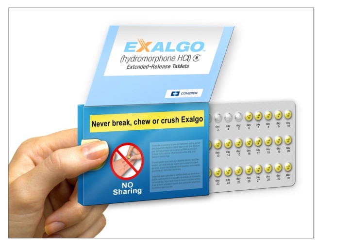 A hand holding a blue box of Exalgo (Hydromorphone HCI) extended-release tablets. The box has a white label with the brand name "Exalgo" written in bold blue letters at the top. Below that there is an illustration of a hand with a pill in it surrounded by a red circle with a line through it that is labeled "NO Sharing". A yellow banner at the top of the package says "Never break chew or crush Exalgo". On the right side of the box there is a blister pack of yellow pills arranged in a grid-like pattern that appears to slide out of the blue box. 