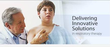 A young boy with short brown hair wearing a white hospital gown being examined by a doctor with a stethoscope. The doctor is holding the boy's chest and appears to be examining his chest. The background is blurred but it seems like the focus is on the doctor and the boy. The image is accompanied by text that reads "Delivering Innovative Solutions in respiratory therapy".