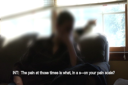 A person sitting on a couch with their back to the camera. The person appears to be in a state of distress with their head in their hands and their body slightly blurred. The background shows a window with blinds and a view of trees outside. The image is accompanied by text that reads "INT: The pain at those times is what in a s-on your pain scale?"