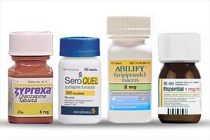 Four different types of tablets. On the left there is a bottle of Zyprexa Glanzapine tablets with a pink cap. Next to it there are two bottles of hero fuel tablets one with a blue cap and the other with a white cap. The bottle with the blue cap has a label that reads "hero fuel" and the label has the word "ABILITY" written on it. The other two bottles have labels that read "2 mg" and "dispersal 1 mg/ml". On the right side of the image there appears to be a small bottle with a brown cap and a label with the same label. All the tablets appear to be new and unused.