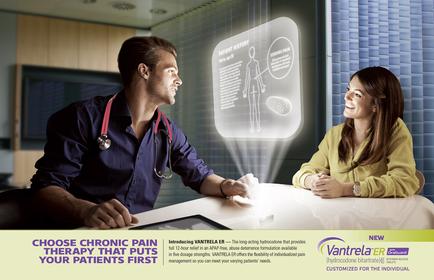 A man and a woman sitting at a desk in a medical office. The man is wearing a blue shirt and a stethoscope around his neck and he is holding a tablet in his hand. The woman is sitting next to him wearing a yellow blouse and she is smiling at him. They appear to be engaged in a conversation. In the background there is a large screen with an image of a person's body and text that reads "Choose Chronic Pain Therapy that puts your patients first". The screen also has a diagram of a heart and a speech bubble indicating that the conversation is about chronic pain therapy. The image also has the logo of cantrell a company that provides new products for the individual.