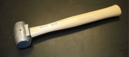 A hammer with a wooden handle. The handle is made of light-colored wood and has a smooth polished finish. The head of the hammer is slightly curved and appears to be made of metal. The hammer has a round silver-colored head with a textured surface. The text on the handle reads "Sterling" and "200 mm". The background is a plain black surface.