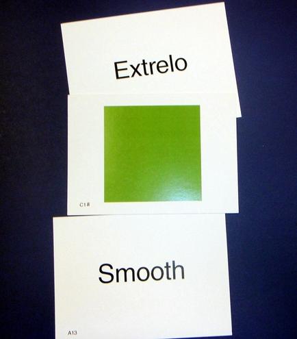 Two white cards with the word "extreme" written in black capital letters at the top. Below the word there is a square with a green color. The card on the left has the number "C18" written on it while the card in the middle has the words "Smooth" written below it. The background is dark blue.