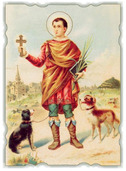 An illustration of a young man dressed in a red robe and holding a cross in his right hand. He is standing in a field with two dogs one black and one brown on either side of him. The man is wearing a white halo above his head and has a serious expression on his face. In his left hand he is holding a bunch of green leaves in his left paw. In the background there is a church and a hill. The sky is blue and the overall color palette of the image is warm and earthy.