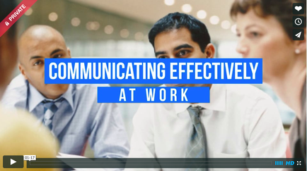 A screenshot from a video titled "Communicating Effectively at Work". It shows a group of three people two men and a woman sitting around a table and engaged in a conversation. The man in the center is a young man with dark hair and a serious expression on his face. He is wearing a white shirt and tie and appears to be speaking to the other two people. The woman on the right is a middle-aged woman with short brown hair and is looking at the man on the left. The background is blurred but it seems like they are in an office or a meeting room. The title of the video is written in blue text on the top right corner of the image.