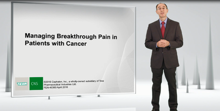 A man in a suit standing in front of a large screen with the text "Managing Breakthrough Pain in Patients with Cancer" on it. The man is wearing a red tie a black suit and glasses. He is standing with his hands clasped together and appears to be giving a presentation or presentation. The background is white and there are several white pillars on either side of the screen. The text on the screen is in black and green and is likely related to the presentation.