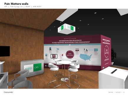 A 3D rendering of a trade show booth with a purple and white color scheme. The booth has a large banner on the wall that reads "Pain Matters Walls" in bold white letters. Below the banner there is a map of the United States with various information about pain management and resources. On the left side of the booth there are two white tables and two white chairs with a green logo on the front. The background is a wooden wall with a TV mounted on it. The overall design is modern and minimalist.
