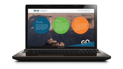 A black Lenovo laptop with a large screen. The laptop is open and the screen displays the homepage of a website called "tea". The website has a blue and orange color scheme with three circles in the center. The circles are labeled "Think" "Plan" "Act" and "Go". The background of the website is a landscape with a mountain range in the distance. The sky is blue and the overall color scheme is blue orange and green. The website appears to be a modern and professional design with a clean and minimalist layout.