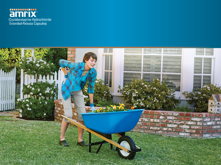 A young woman pushing a blue wheelbarrow in a garden. She is wearing a blue plaid shirt khaki pants and black shoes. The garden has a brick wall and a white picket fence in the background. There are plants and flowers in the garden and a birdhouse on the right side of the image. The woman appears to be in the process of planting or tending to the plants. The image is accompanied by text that reads "amrix extended-release capsules".