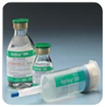 A syringe and two vials of an unknown substance. They all have the same white labels with graphic elements in green with text in black and red. The syringe appears to be made of semi-translucent plastic with a blue cap. The vials appear to be made of clear glass with green lids. The labels are too blurry to read. The photograph was taken against a light blue gradient background.