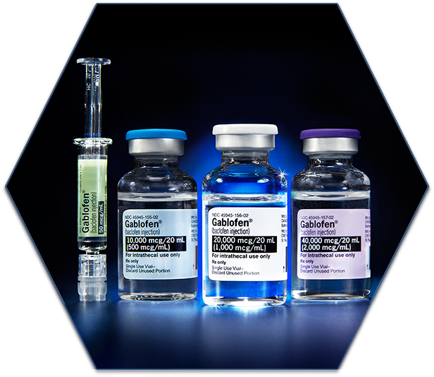 A prefilled syringe and three small glass vials of Gablofen (baclofen injection) in various dosages (50 mcg/mL 10000 mcg/mL 20000 mcg/mL and 40000 mcg/mL from left to right). All are photographed against a dark background which is primarily black with a blue spotlight shining through the syringe and vials (from behind).