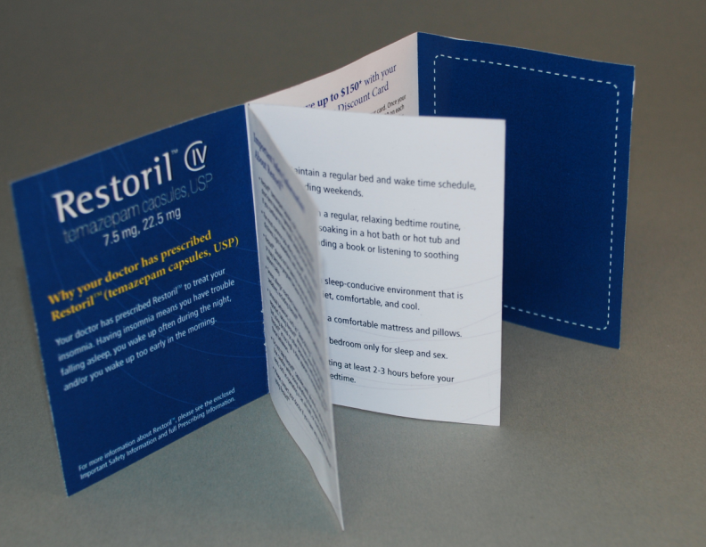 A blue and white booklet with the text "Restoril IV" on the left side. The brochure is open revealing the contents inside. The subheading on the left side is: "Why your doctor has prescribed Restoril (temazepam capsules USP)." The left section has a blue background with white and yellow text. There are several white pages with black text at the center of the booklet that are fanned open but difficult to read in full. The text appears to relate to maintaining good sleep hygiene. 