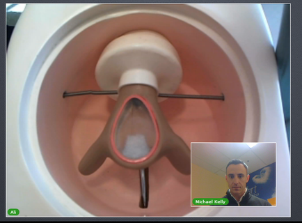 A close-up of a medical device specifically a ventilator. The device is white in color and has a cylindrical shape with a pointed end. The ventilators are attached to the device with two metal rods. In the center of the device there is a small amount of white material which appears to be a surgical instrument. On the right side of the image there are two smaller images one of a man in a suit and the other of a woman in a blue shirt. The man in the suit is looking directly at the camera with a serious expression.