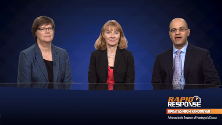 A screenshot from a news program called Rapid Response. It shows three people sitting at a desk in front of a blue background. On the left is a woman with short brown hair and glasses wearing a blue blazer and a black top. In the middle is a middle-aged woman with blonde hair and a red blouse and on the right is a bald man with glasses and a suit. All three people are looking at the camera and appear to be engaged in a conversation. The text on the image reads "Rapid Response Updates from Vancouver: Advances in the Treatment of Huntington Disease".