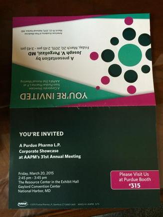 A photograph of a brochure or invitation card. The brochure is folded in half with the left side facing towards the viewer. The left side of the brochure has a white background with a green and pink polka dot pattern. On the right side there is a pink banner with the text "You're Invited" in bold black letters. Below the banner there are two lines of text in white. The text is in a modern sans-serif font and is centered on the page. The brochure appears to be a flyer or brochure for an event as indicated by the text on the top right corner. The top left corner has a pink and green polka-dot pattern while the bottom right corner has the text in a darker green color. The bottom left corner of the page has a small pink banner that reads "Please join us at the event" in white letters. Overall the image is of a business card or invitation for a conference or event.