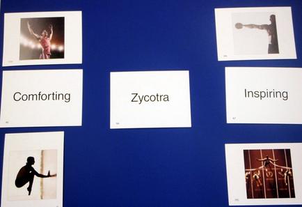 A collage of six square photographs arranged in a grid-like pattern on a blue background. Each photograph is accompanied by a white card with the word "Comforting" written in black text. The first photograph on the top left shows a woman in a pink dress with her arms raised in the air. The second photograph is a black and white photograph of a person in a dance pose. The third photograph is of a dancer in mid-air with their arms stretched out to the sides. The fourth photograph is from the top right corner of the collage. The fifth photograph is in the center of the image with the text "socotra" written above it. The sixth photograph is on the bottom left corner with a silhouette of a woman performing a dance move. The seventh photograph is to the right of the first photograph and the eighth photograph is at the bottom right corner. Overall the image conveys a sense of comfort and inspiration.